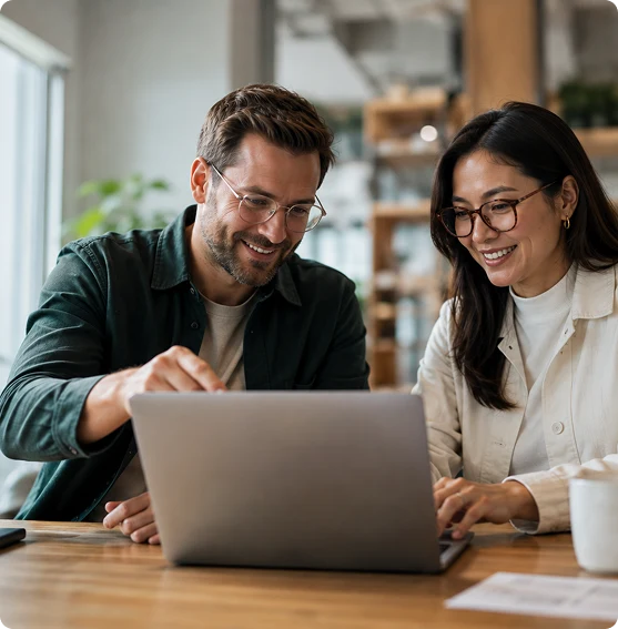 Business partners reviewing an online program on a laptop